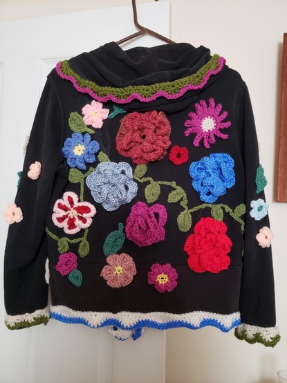 The back of the same hoodie with more flowers, etc